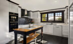 Modern farmhouse kitchen with large windows and premium appliances in Barossa luxury accommodation