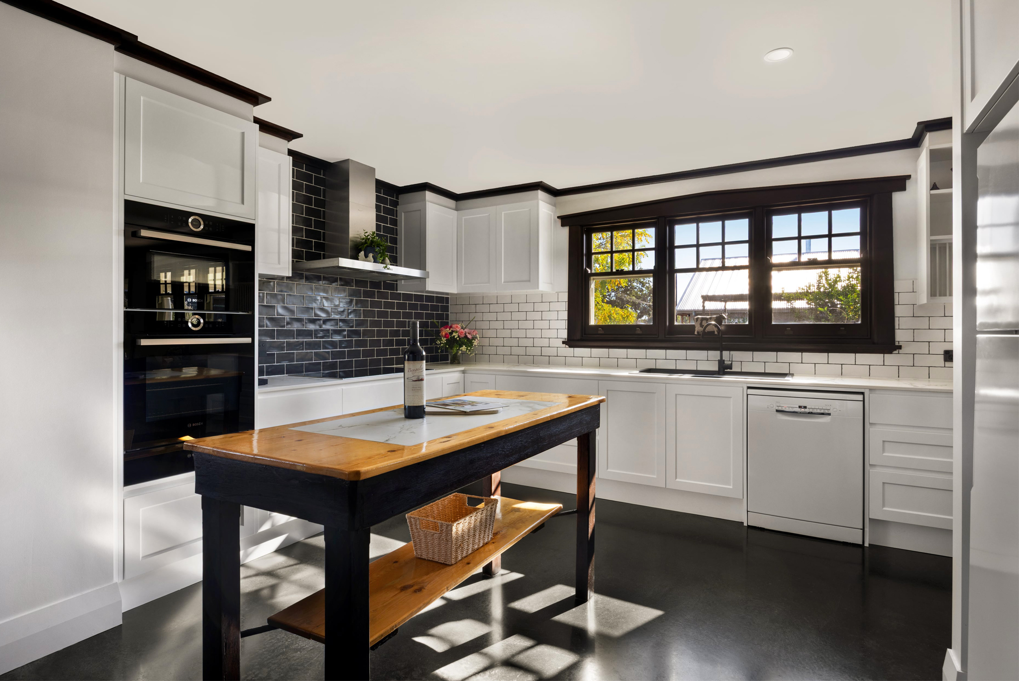 Modern farmhouse kitchen with large windows and premium appliances in Barossa luxury accommodation