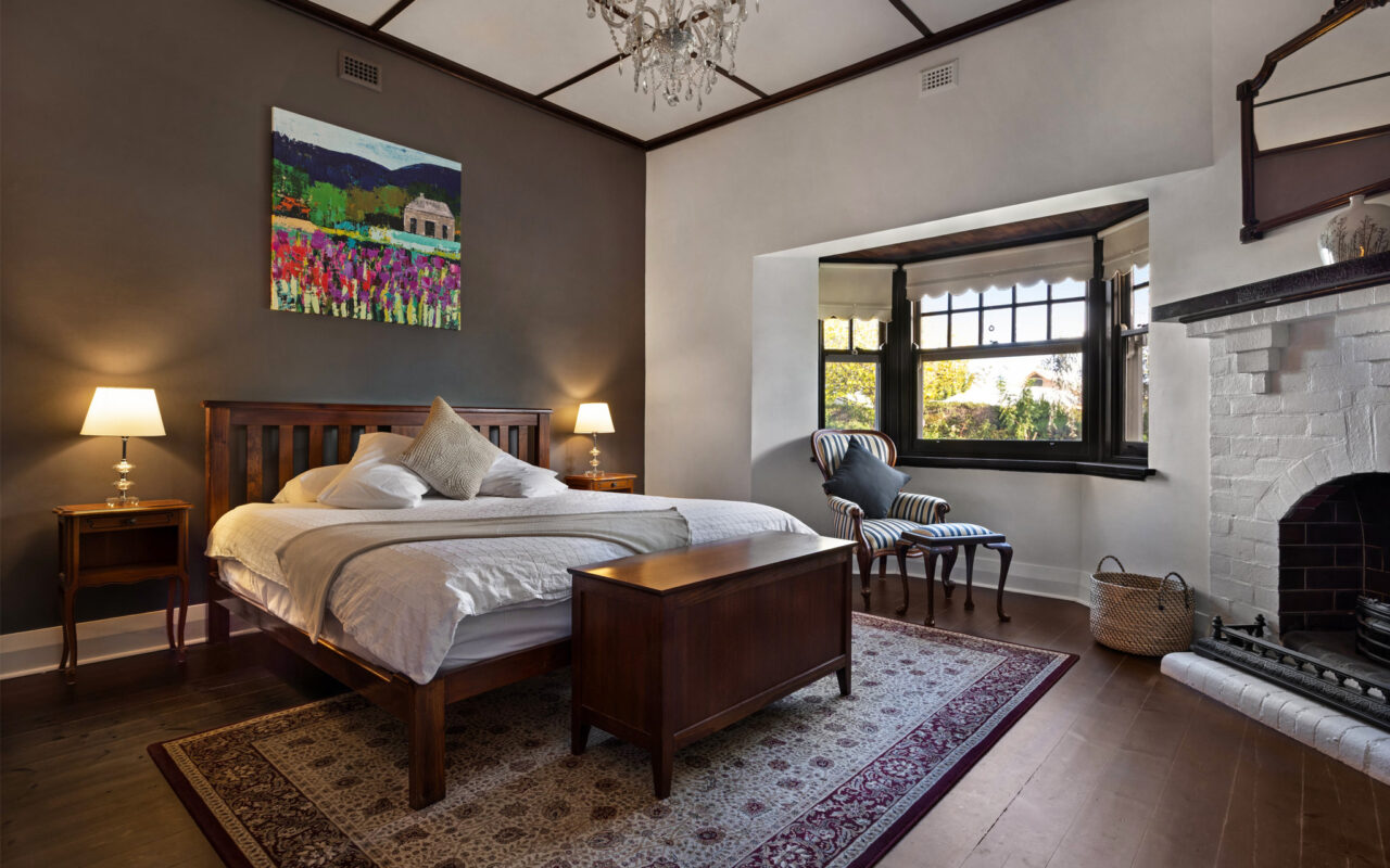Spacious master bedroom with fireplace and high ceilings in luxury Barossa Valley accommodation