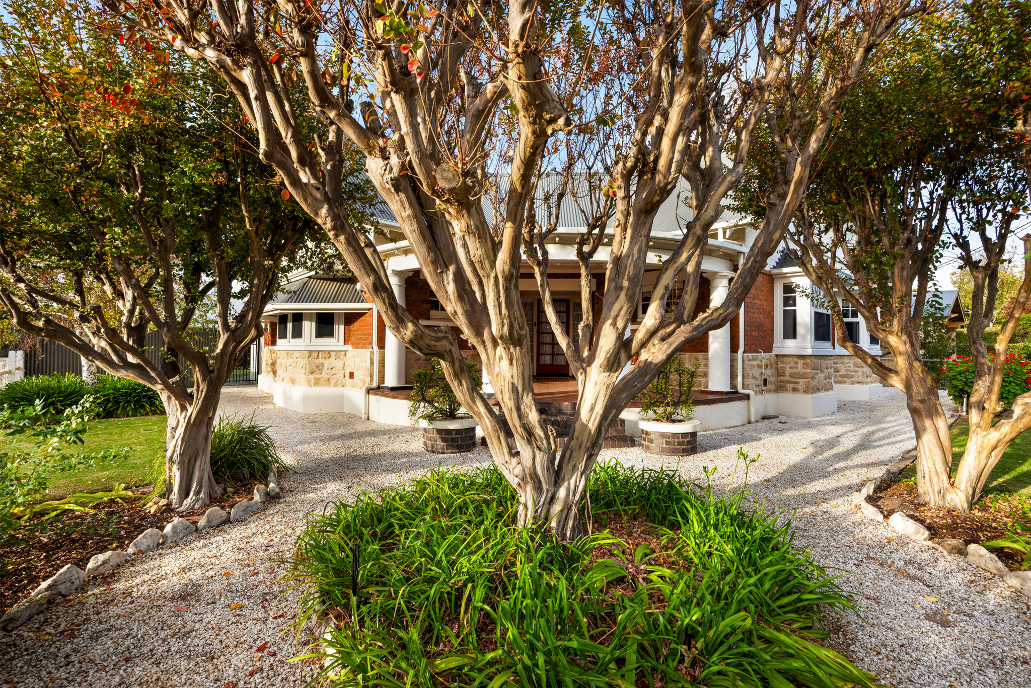 Traditional wraparound verandah entrance surrounded by gardens at heritage Barossa Valley accommodation