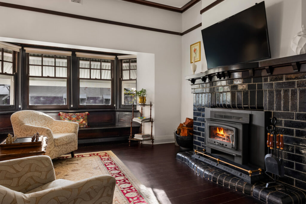 Spacious living room with leather lounge and fireplace in luxury Barossa Valley retreat