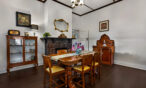 Elegant dining room with fireplace and period furnishings in restored Barossa heritage home