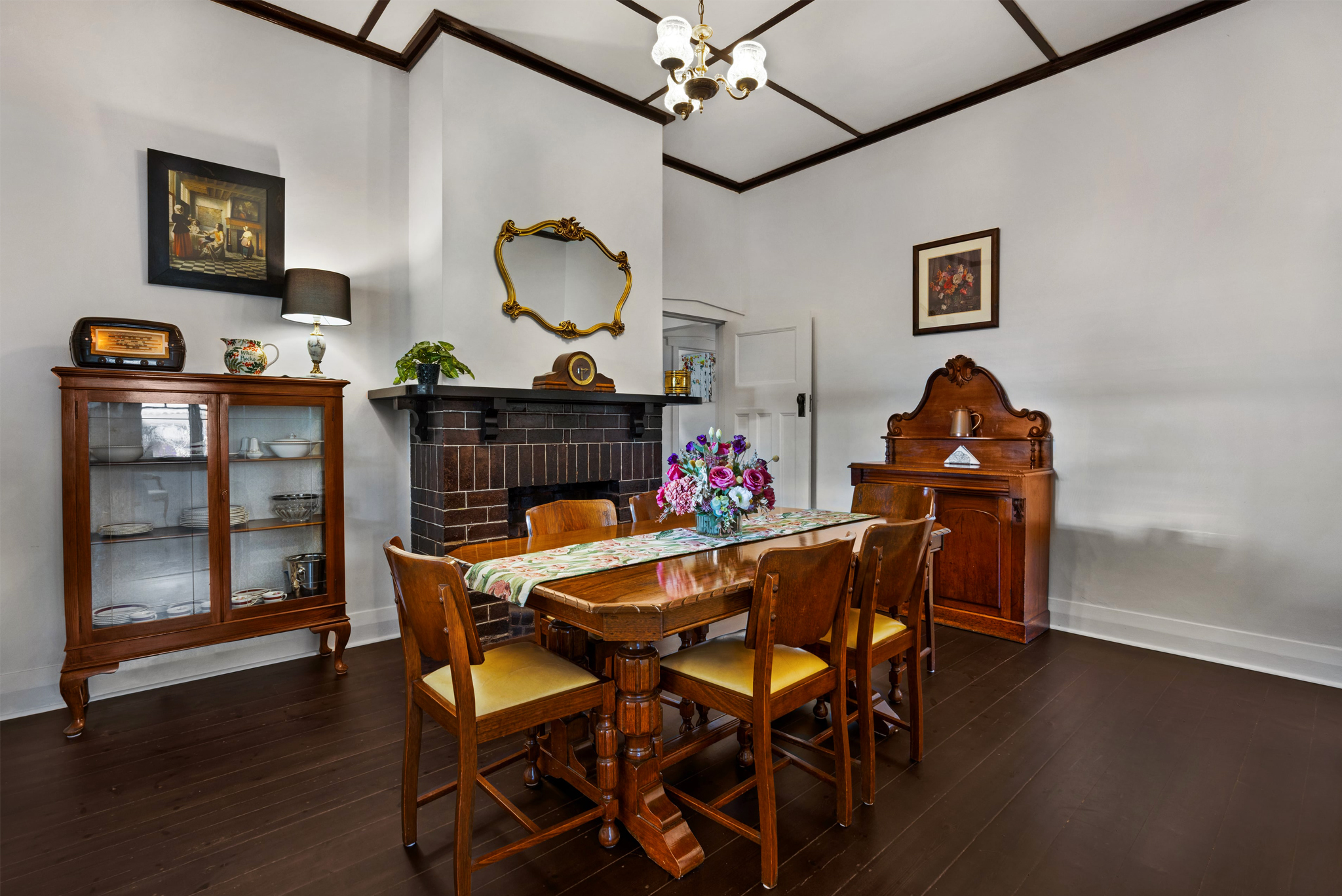 Elegant dining room with fireplace and period furnishings in restored Barossa heritage home