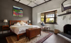 Spacious master bedroom with fireplace and high ceilings in luxury Barossa Valley accommodation