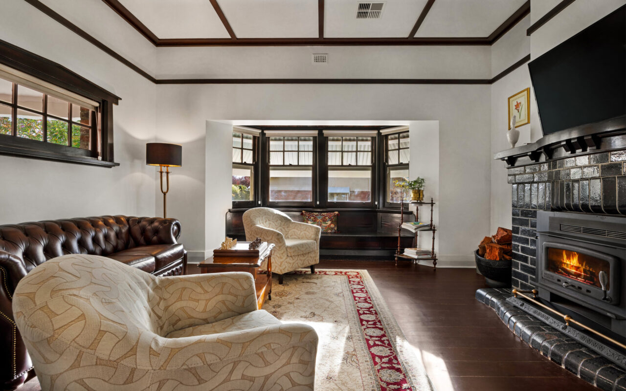 Spacious living room with leather lounge and fireplace in luxury Barossa Valley retreat