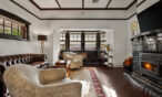 Spacious living room with leather lounge and fireplace in luxury Barossa Valley retreat