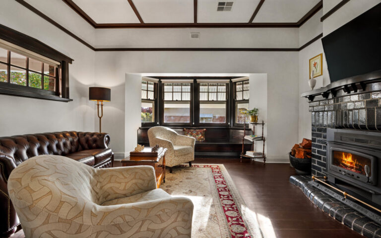 Spacious living room with leather lounge and fireplace in luxury Barossa Valley retreat