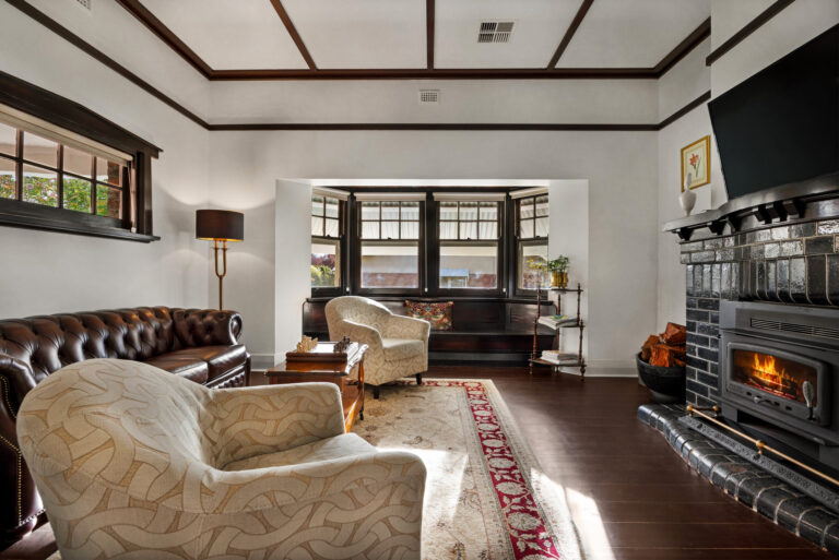 Spacious living room with leather lounge and fireplace in luxury Barossa Valley retreat