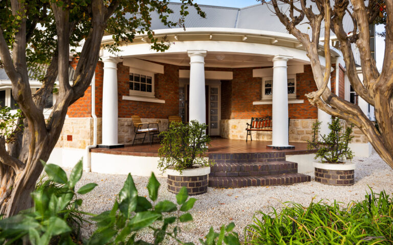 Traditional wraparound veranda entrance surrounded by gardens at heritage Barossa Valley accommodation
