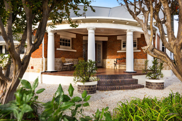 Traditional wraparound veranda entrance surrounded by gardens at heritage Barossa Valley accommodation