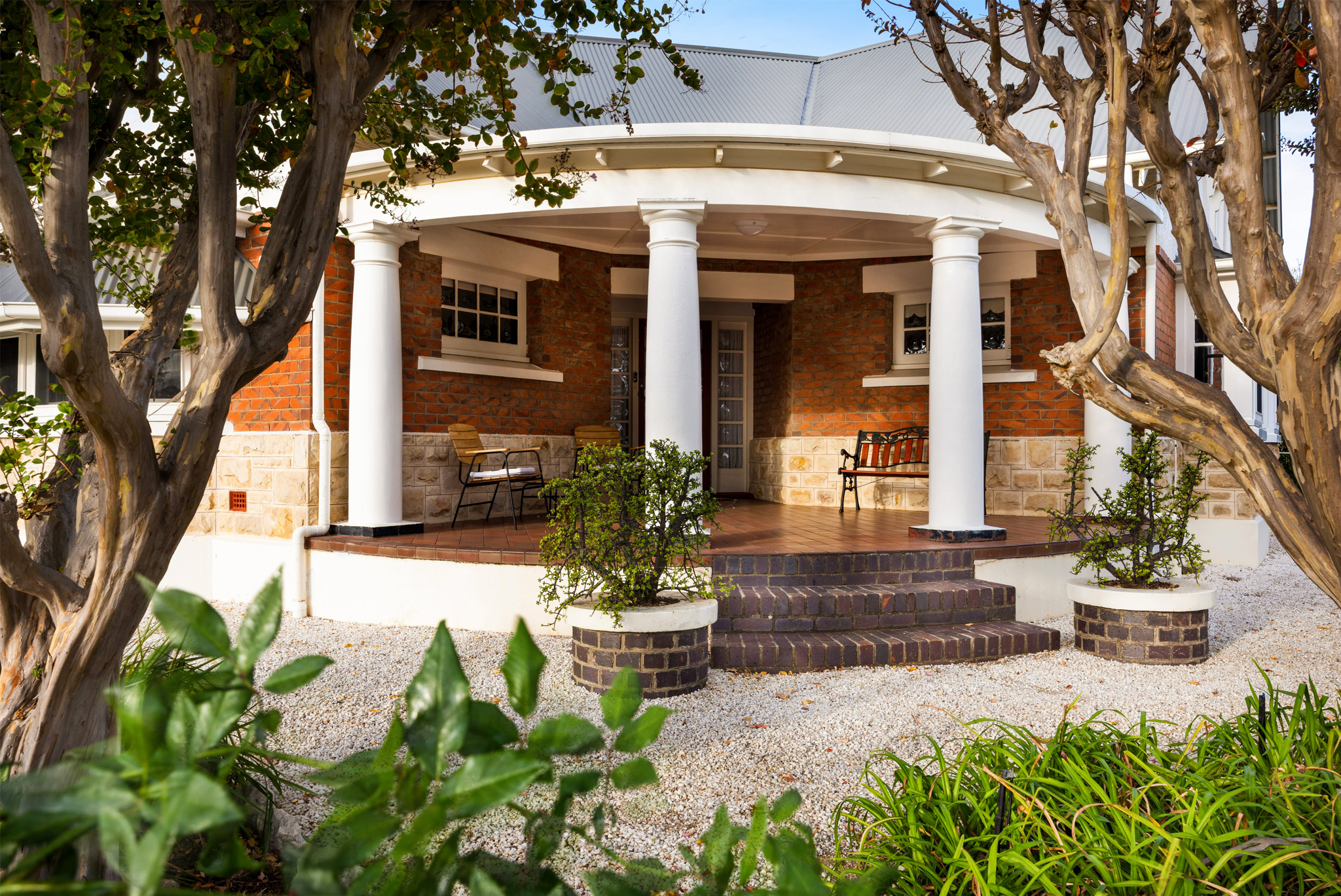 Traditional wraparound veranda entrance surrounded by gardens at heritage Barossa Valley accommodation
